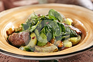 Salad with Lamb Meat and Zucchini on Rustic Style Hay Background