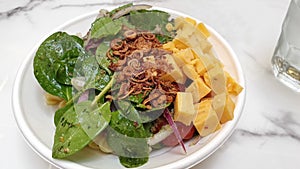 Salad with lava egg, spinach close up view