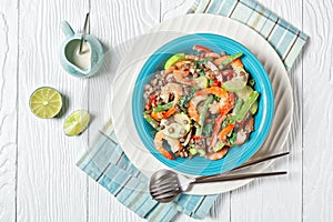 Salad of lentils  shrimps  wilted kale on a plate
