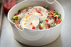 Salad with lettuce, brie, fried pears, camembert, walnuts, red onion, tomatoes and raspberry vinaigrette dressing