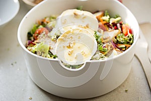 Salad with lettuce, brie, fried pears, camembert, walnuts, red onion, tomatoes and raspberry vinaigrette dressing