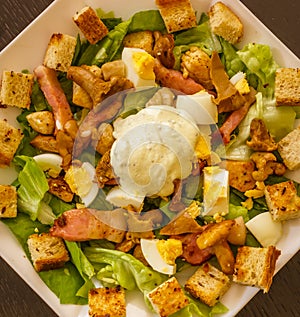 Salad with lettuce, chicken, bacon, mushrooms, eggs, croutons an