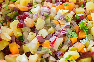 Salad made of potatoes, carrots, beat, parsley and onion cut in pieces