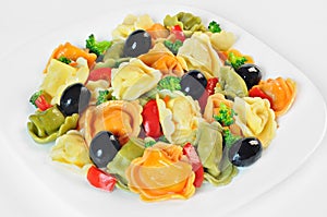 Salad made with tortellini, olives, broccoli, red pepper, on a plate