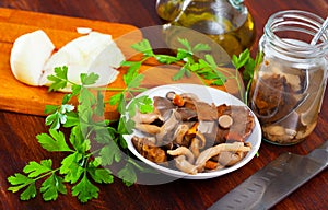 Salad of marinated mushrooms with onion and greens