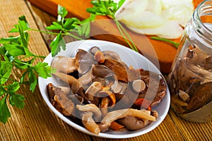 Salad of marinated mushrooms with onion and greens