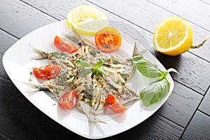 Salad marinated sardines with basil and tomato