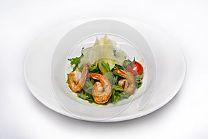 Salad of meat and vegetables in a white plate