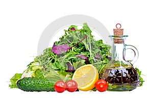 Salad mix with bottle of olive oil and lemon isolated on white