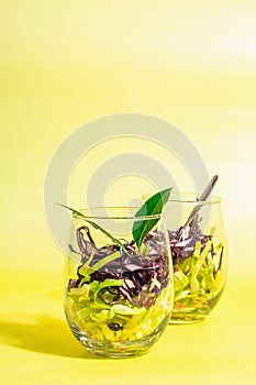 Salad from mixed cabbage served in glasses. Fresh vegan vitamin food. Spices, olive oil, dry berries