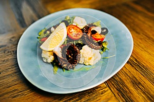 Salad with octopus and vegetables.