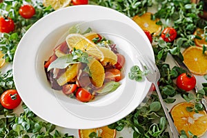 Salad in oranges, tomatoes and bacon