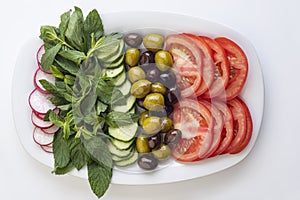 Salad plate of cucumber , tomato, and olives assorted in a plate  on white