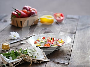 Salad in the plate and fresh vegetables in basket