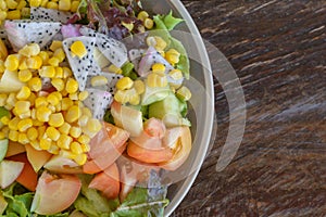 Salad on the plate on a wood table