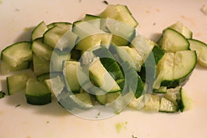 Salad preparation - cutting cucumber into pieces