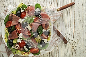 Salad prosciutto with cheese and olives