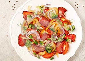 Salad with Prosciutto, tomatoes, onion, sweet pepper and broccoli. Cold snacks. Top view. Close up