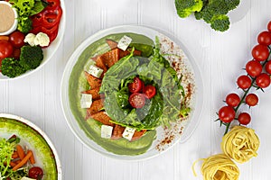 Salad of pumpkin, spinach, feta cheese and cherry tomatoes. Topped with sauce. Keto diet