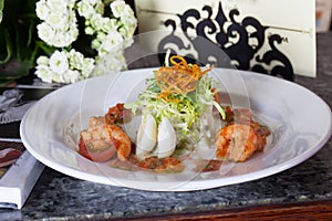 Salad with quail egg shrimp, tomatoes, cabbage in a restaurant Still Life holiday glasses