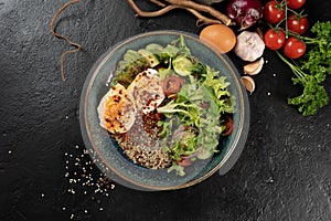 Salad with quinoa, avocado, poached egg and vegetables.