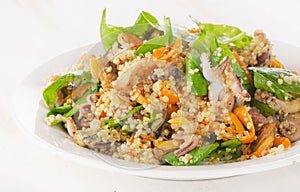 Salad with quinoa and seafood on a white plate.