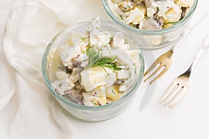 Salad rasols made of herring, cucumber and potato, dressed with mayonnaise and mustard