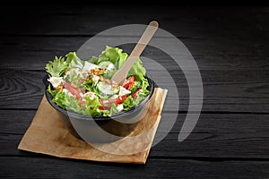 Salad with red fish or tuna and lettucce in a plastic bowl. Healthy fast food.