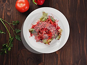 Salad of red and white cabbage and sweet red pepper, seasoned with olive oil