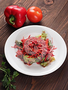 Salad of red and white cabbage and sweet red pepper, seasoned with olive oil