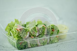 Salad roll vegetables wrapped in flour on clear plastic box