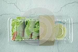 Salad roll vegetables wrapped in flour on clear plastic box