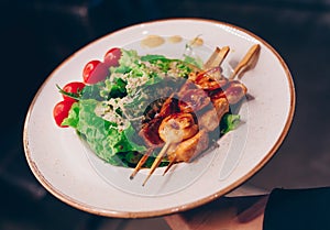 Salad rucola squid Shrimp asparagus ,  seafood salad at restaurant, close up view. Eating Asian Japanese food  leisure concept