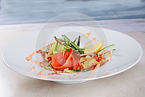 Salad with salmon and iceberg lemon, cucumber, pink sauce,