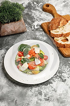 Salad with salmon, sheep cheese, herbs and tomatoes. Mediterranean diet. Delicious and healthy food recipes. Vertical shot