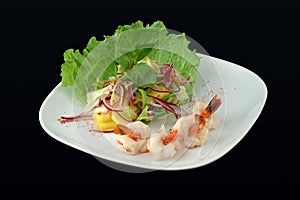 Salad with seafoods on a black background