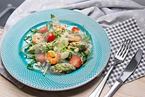 Salad of seasonal greens and herbs with shrimps and guacamole