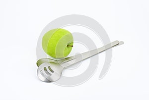 Salad servers and green apple