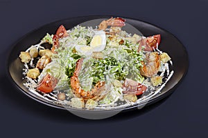 Salad with shrimp and croutons, tomatoes, cheese and sauce. Boiled egg.