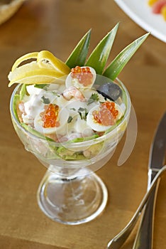 Salad with shrimps, avocado, pineapple, quail eggs