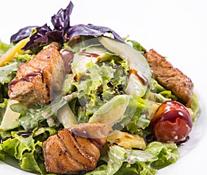 Salad with smoked red fish with fresh lettuce leaves and basil