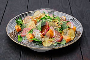 Salad with soft cheese, radish, pear, pumpkin and sun dried tomato