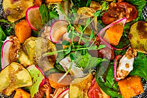 Salad with soft cheese, radish, pear, pumpkin and sun dried tomato