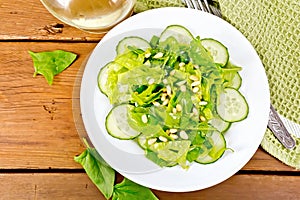 Salad from spinach and cucumber with lettuce on board top