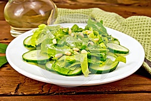 Salad from spinach and cucumber with napkin on board