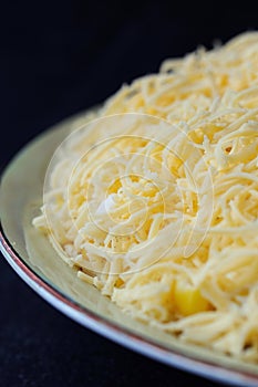 Salad sprinkled with grated cheese closeup