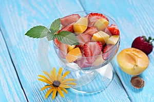 Salad of strawberry and apricot with mint leaves