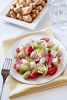 Salad with three kinds of tomatoes, boiled white kidney beans an