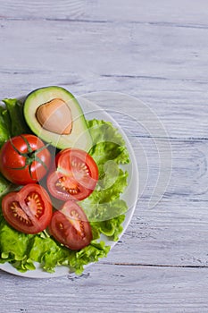 Salad of tomato, lettuce and avocado.