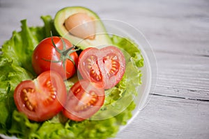 Salad of tomato, lettuce and avocado.